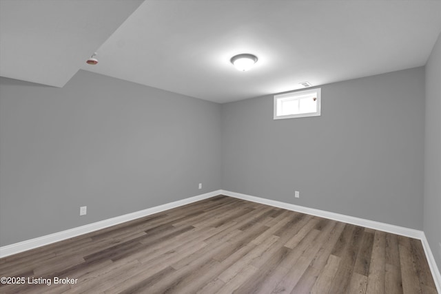 interior space featuring wood finished floors and baseboards
