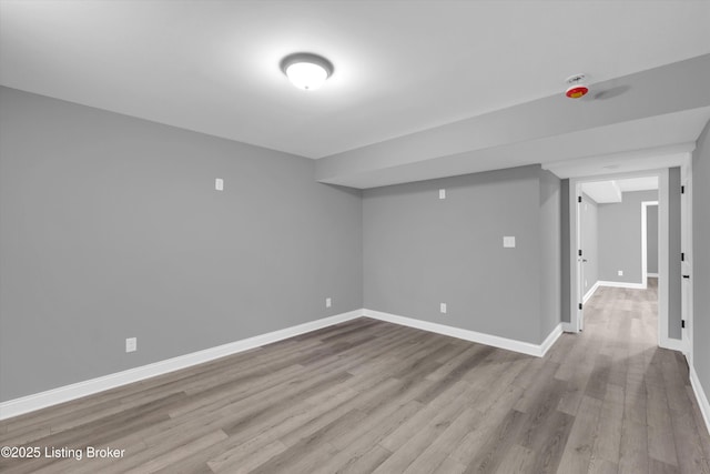 finished basement with wood finished floors and baseboards