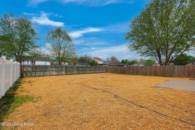 view of yard with a fenced backyard