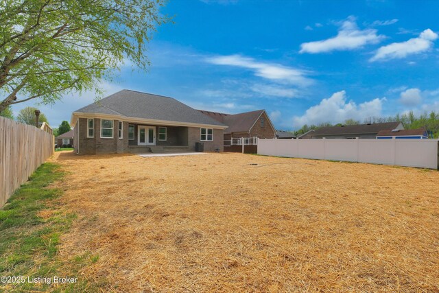 back of property with a patio and a fenced backyard