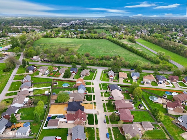 birds eye view of property with a residential view