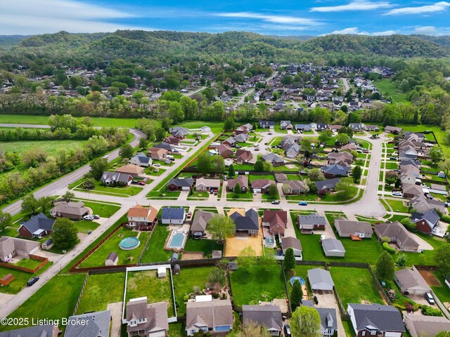 birds eye view of property featuring a residential view and a forest view