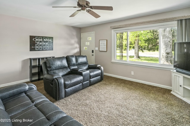 living area with carpet, ceiling fan, and baseboards