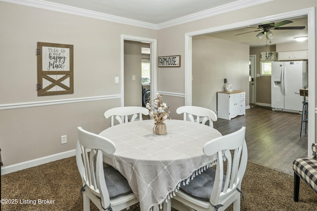 dining room featuring baseboards, a ceiling fan, and crown molding