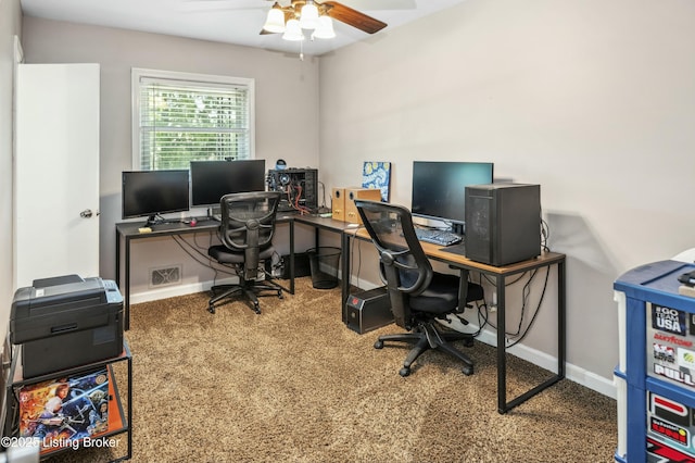 carpeted office space with ceiling fan and baseboards