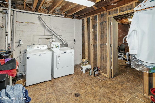 unfinished below grade area with washing machine and clothes dryer