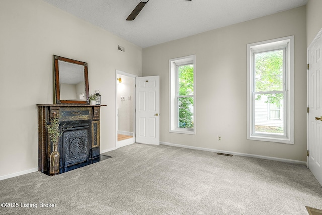 309 W Madison St, La Grange, KY 40031 - unfurnished living room featuring healthy amount of natural light, carpet, a ceiling fan, baseboards, and a textured ceiling