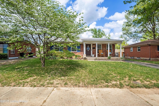 view of front facade with a porch, a front lawn, and brick siding