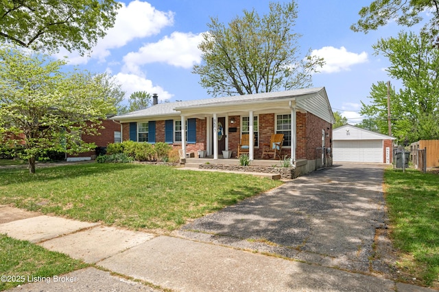 ranch-style house featuring a porch, a front lawn, an outbuilding, a detached garage, and brick siding