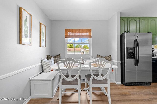 dining area featuring baseboards, breakfast area, and light wood finished floors