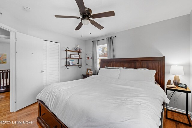 bedroom with ceiling fan, light wood-style flooring, and a closet