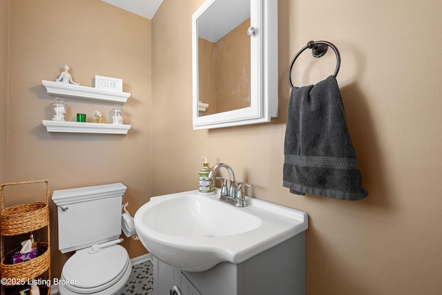 bathroom featuring toilet and vanity