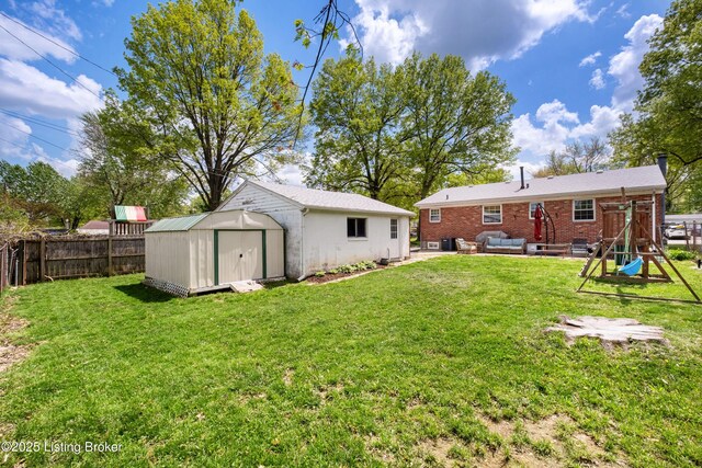 back of property with an outdoor structure, a fenced backyard, a lawn, an outdoor hangout area, and a storage unit