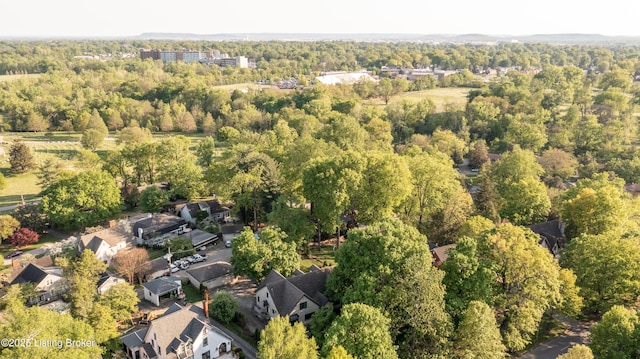 birds eye view of property with a wooded view and a residential view