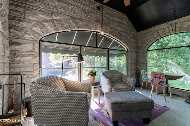 sunroom featuring a ceiling fan and a wealth of natural light