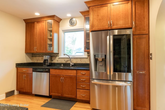 kitchen featuring light wood-type flooring, a sink, appliances with stainless steel finishes, and visible vents