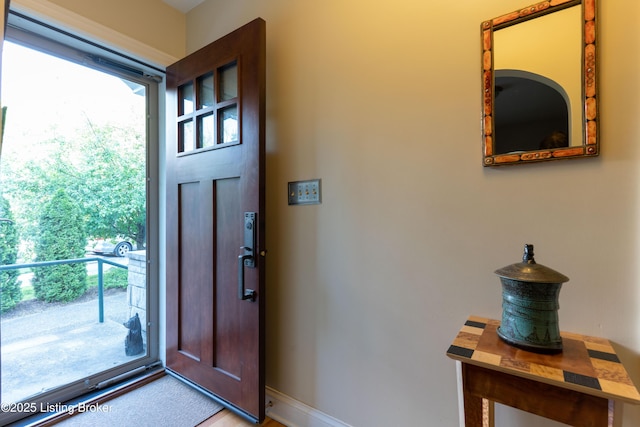 doorway to outside with baseboards
