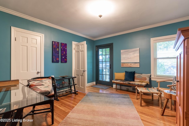 entrance foyer featuring crown molding, light wood-style flooring, and baseboards