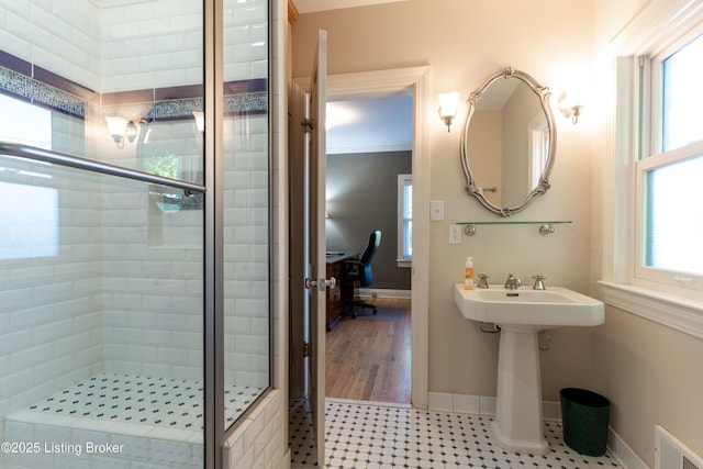 full bath featuring visible vents, a stall shower, and baseboards