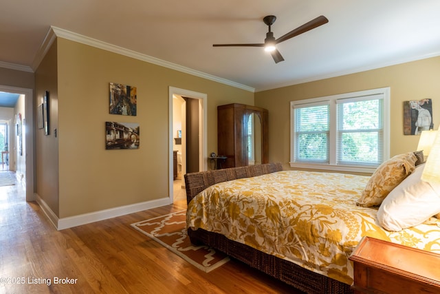 bedroom with baseboards, wood finished floors, ceiling fan, and crown molding