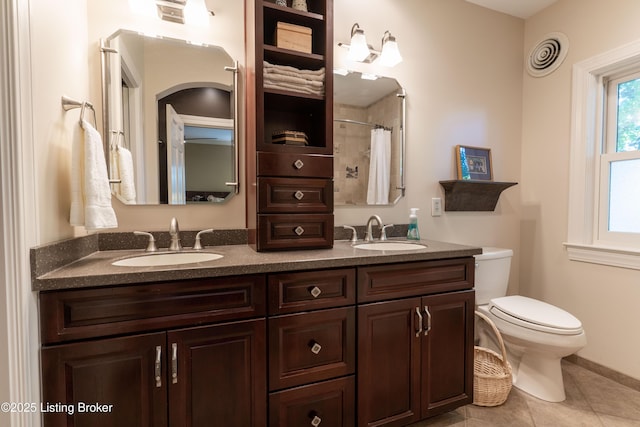 bathroom featuring tile patterned floors, visible vents, toilet, and a sink