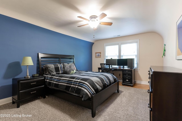 bedroom featuring a ceiling fan, visible vents, and baseboards