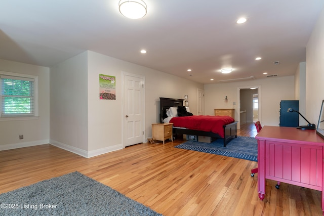 bedroom with baseboards, recessed lighting, light wood-style floors, and multiple windows