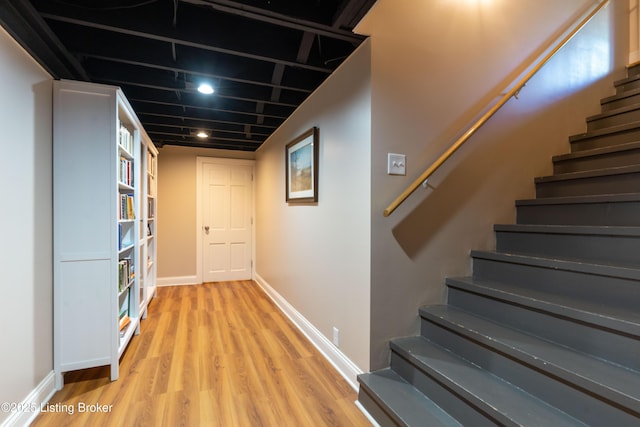 interior space featuring baseboards and wood finished floors