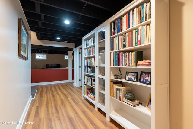 hall with wood finished floors and recessed lighting