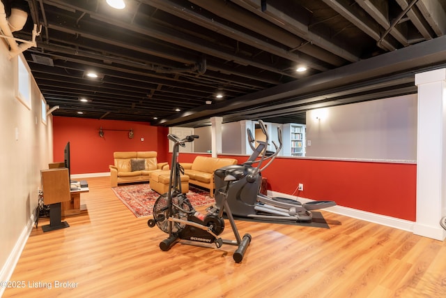 exercise room with wood finished floors and baseboards