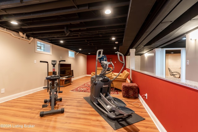 exercise room featuring wood finished floors and baseboards