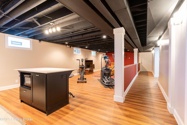 below grade area featuring baseboards and light wood-type flooring