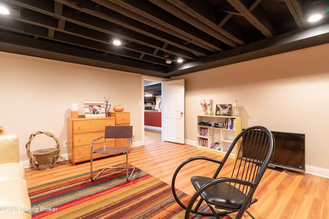 living area featuring wood finished floors and baseboards