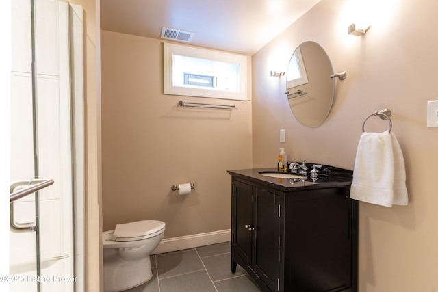 bathroom with vanity, tile patterned floors, toilet, visible vents, and baseboards