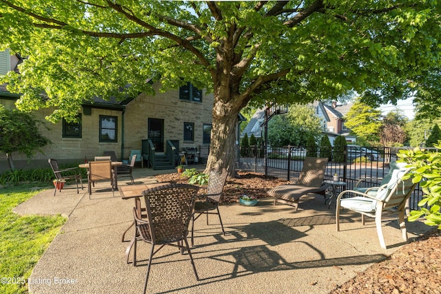 view of patio / terrace featuring fence