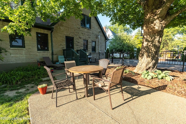 view of patio / terrace with outdoor dining space and fence
