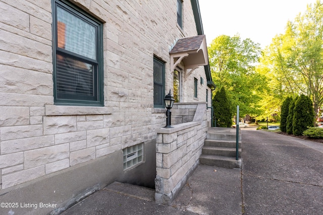 view of side of home featuring stone siding