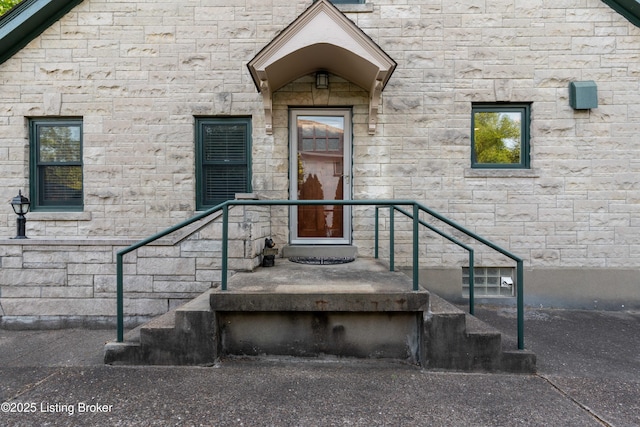 view of exterior entry featuring stone siding
