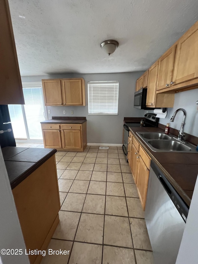4213 Shenandoah Dr, Louisville, KY 40241 - kitchen with a sink, dark countertops, stainless steel appliances, baseboards, and light tile patterned flooring