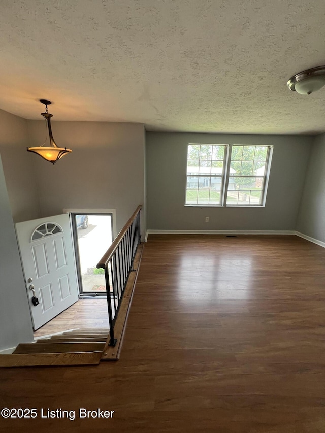 4213 Shenandoah Dr, Louisville, KY 40241 - foyer featuring dark wood-style floors, a textured ceiling, and baseboards