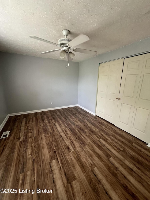 4213 Shenandoah Dr, Louisville, KY 40241 - unfurnished bedroom featuring a textured ceiling, visible vents, dark wood finished floors, and a closet