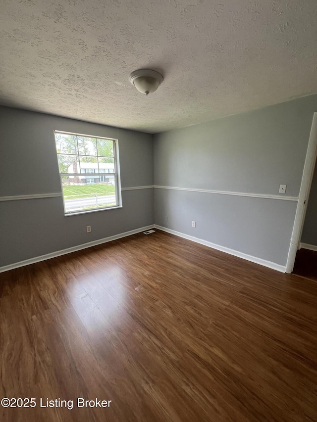 4213 Shenandoah Dr, Louisville, KY 40241 - empty room featuring dark wood finished floors, baseboards, and a textured ceiling