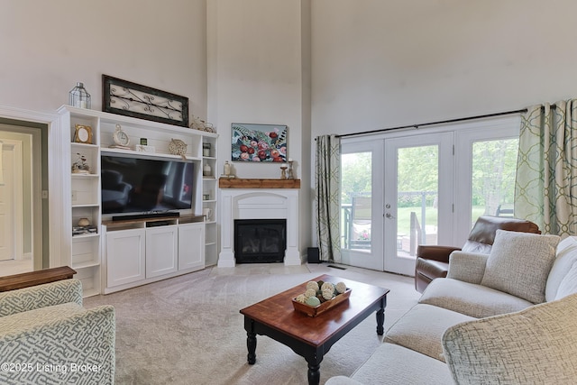 3817 Carriage Hill Dr, Crestwood, KY 40014 - living area with a high ceiling, light colored carpet, french doors, and a glass covered fireplace