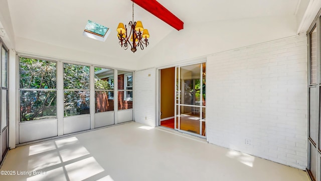 unfurnished sunroom with finished concrete floors, lofted ceiling with beams, a notable chandelier, and brick wall