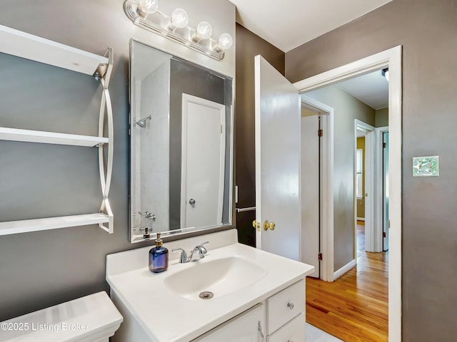 bathroom with wood finished floors and vanity