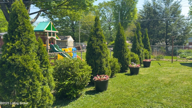 view of yard featuring a playground and fence