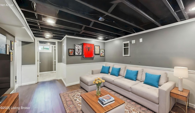 living room featuring wood finished floors and a wainscoted wall