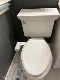 bathroom with toilet and tile patterned floors