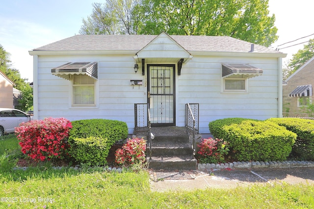 bungalow-style home with a shingled roof