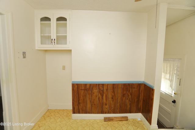 unfurnished room with baseboards